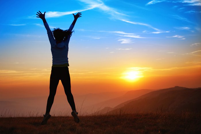 sobriety is awesome - happy woman at sunset - victory addiction recovery center