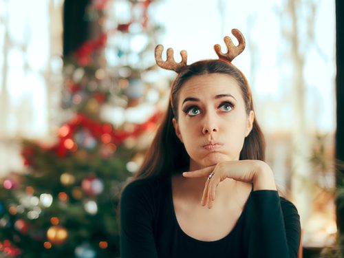How to Survive the Holidays in Recovery - woman bored at christmas party