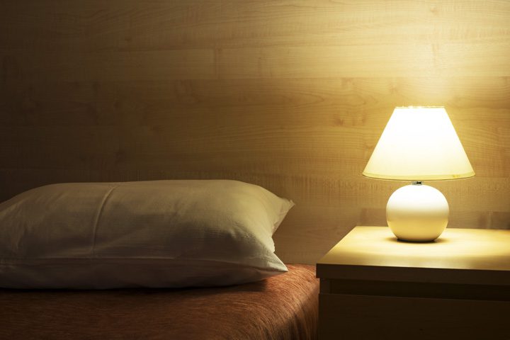 bed and night stand with lamp
