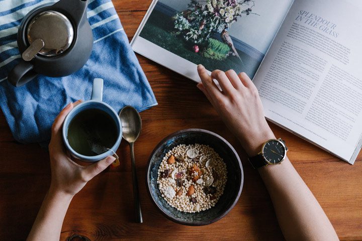 aerial view person eating healthy meal and reading magazine - stress