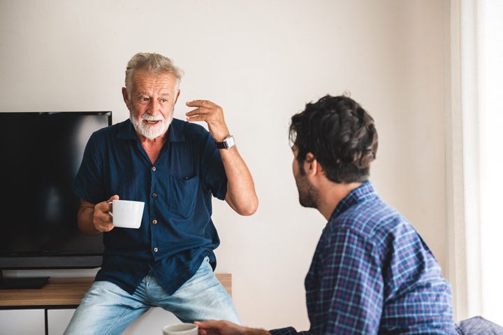 senior father talking to adult son - adult children