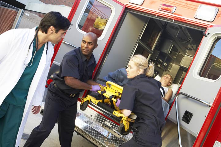 paramedics getting a woman out of the ambulance at the hospital - opioid overdose