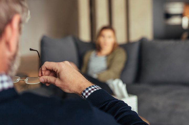 male counselor listening to female patient - mental health