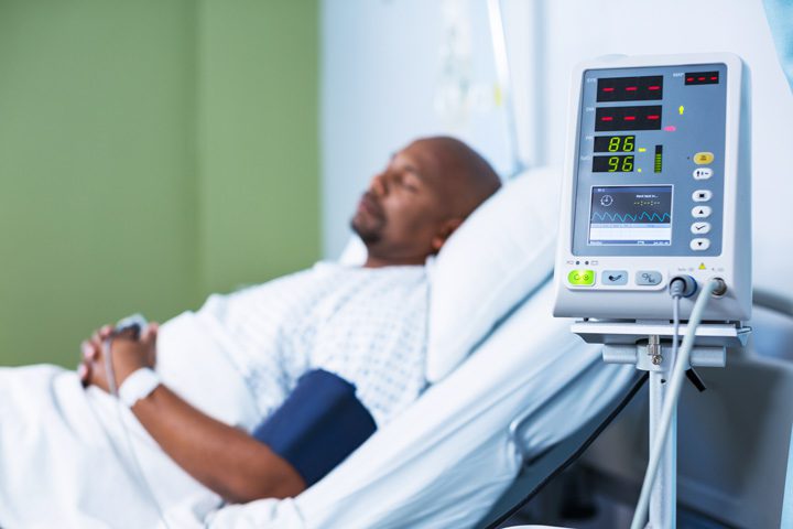 handsome middle age Black man in hospital bed - effects of addiction