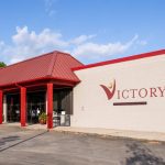 Louisiana Alcohol Recovery Center, Best Choice for Addiction Treatment in Lafayette, building exterior with American flag and benches - Victory Addiction Recovery Center - Lafayette substance use disorder treatment center, Alcohol Recovery Center Near Lake Charles,