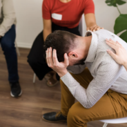 A man in a group therapy setting.