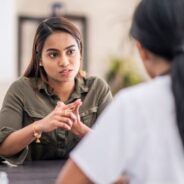 Woman speaking seriously with a healthcare professional