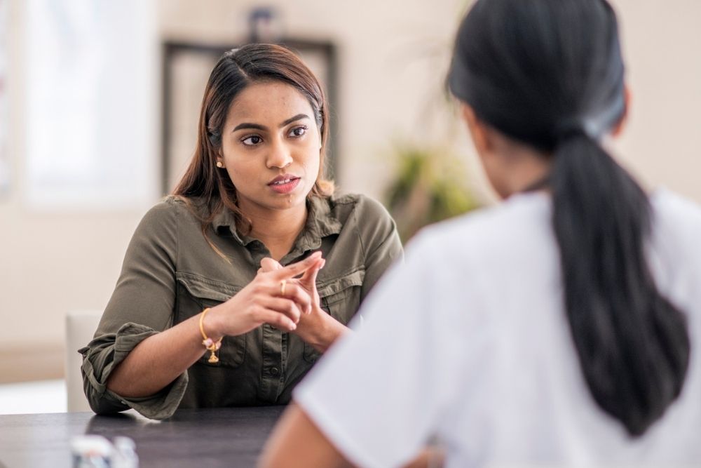Woman speaking seriously with a healthcare professional