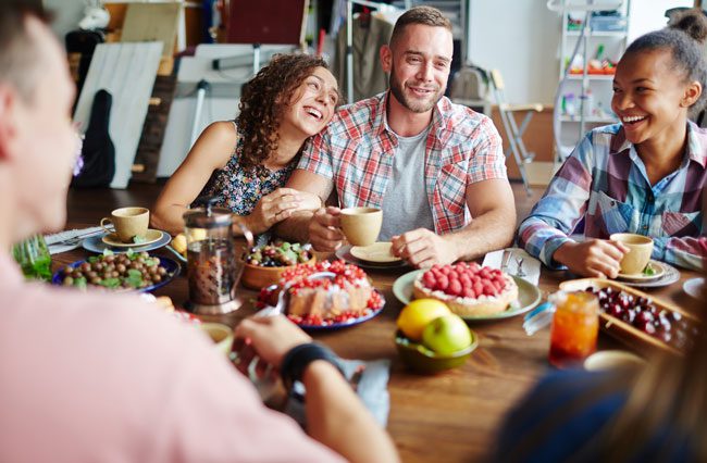 How-to-Prepare-for-Your-First-Thanksgiving-in-Recovery - friends eating holiday meal