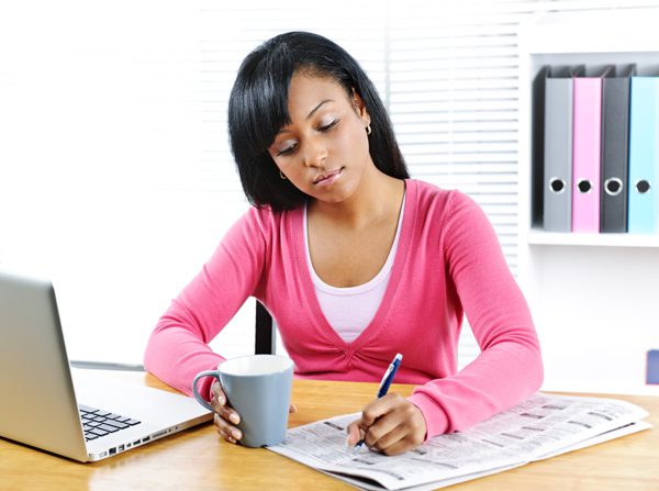Job Hunting in Recovery - girl with coffee newspaper and laptop