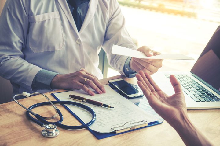 doctor handing patient a prescription - prescription