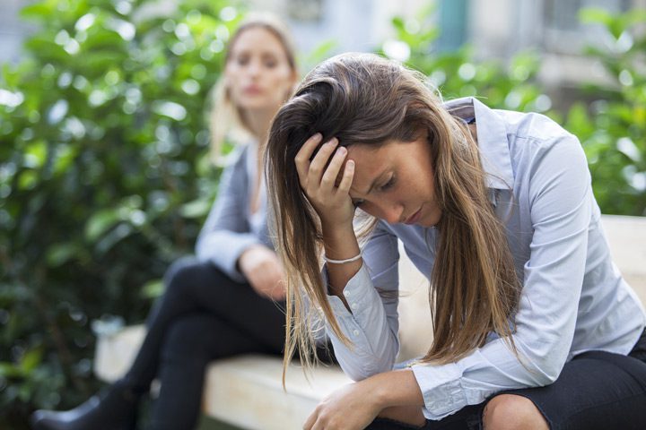 two women sitting outside