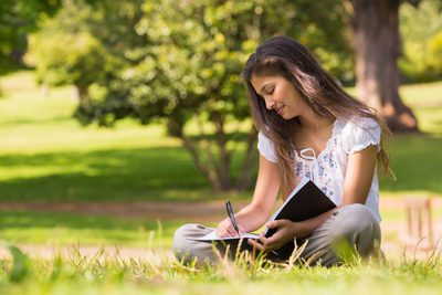 Rewriting Stories: Using Creative Writing in Recovery - woman writing in a book