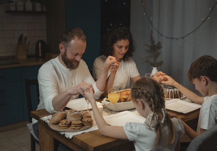family praying eating table dinner recovery