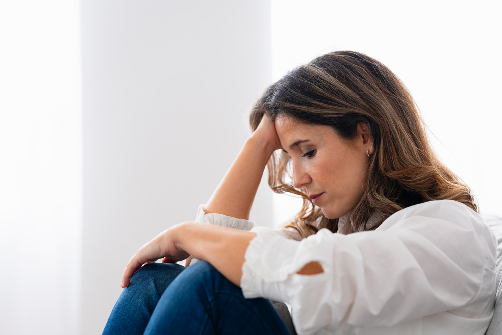 sad woman sitting with her head in her hands