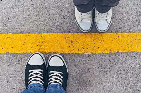 setting boundaries in sobriety - top view of shoes at line - victory addiction recovery center